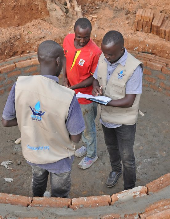 Oasis Water field team planning a well at a construction site