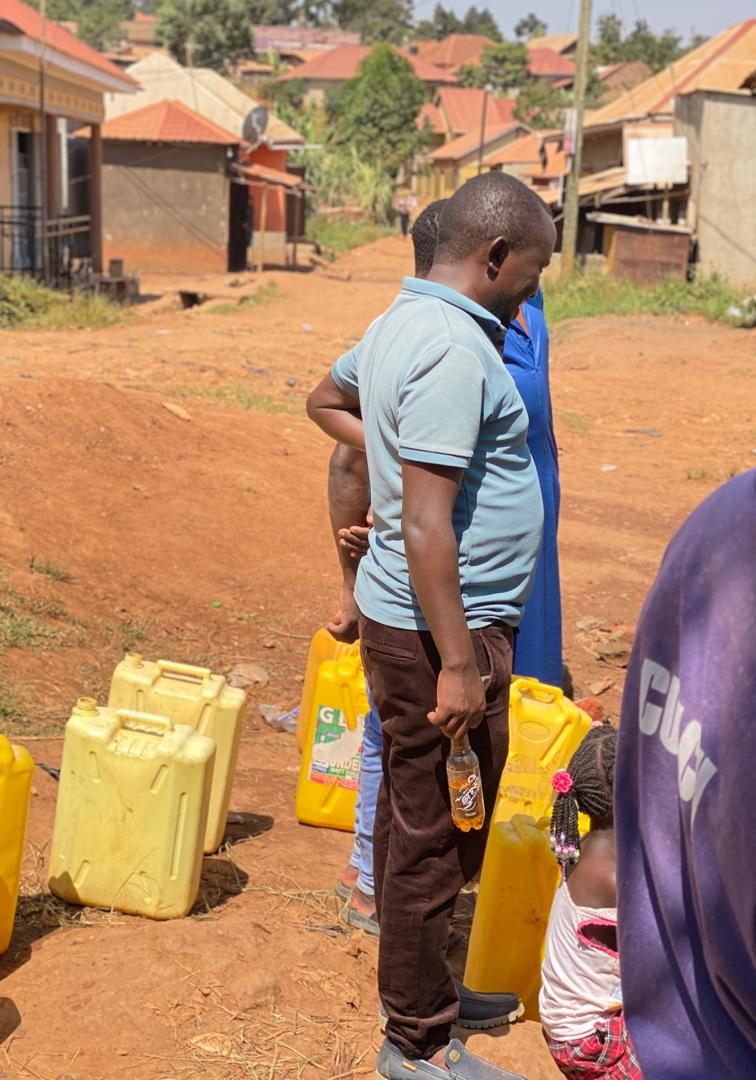 Community members collecting water together